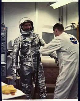 Walter M Prints: Man Assisting Walter Schirra into Spacesuit