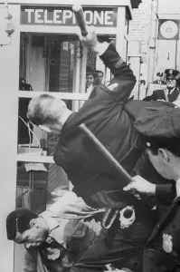 Crisis Prints: Man Being Beat by Policeman with Nightstick