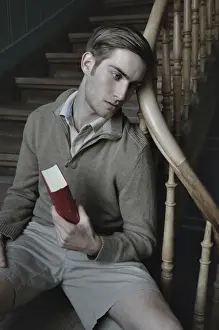 Railings Prints: Man with book in a stairwell, nostalgic portrait