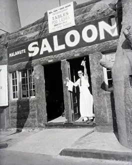 Man With Bottle In Door Of Malemute Salo