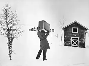 Man Bringing TV Set To Rural House
