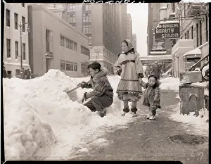 Man Building Snow Hut on Street