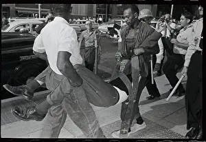 Jackson Prints: Man Being Carried by Two Officers