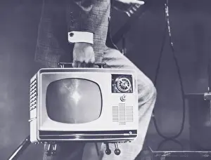 Television Set Prints: Man carrying portable television up steps, low section (B&W)