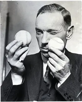 Umpire Prints: Man Comparing Two Baseballs