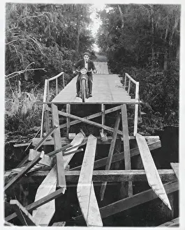 Caution Prints: Man Crossing Bridge on Motorcycle