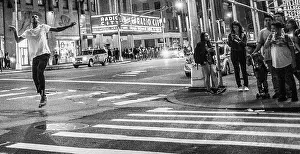 Man dancing in the street down the street from Radio City Music Hall