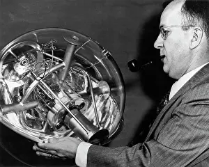 Satellite Prints: Man Displays Rocket Instrument Model