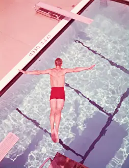 Only Mature Men Prints: Man diving into swimming pool, overhead view. (Photo by H