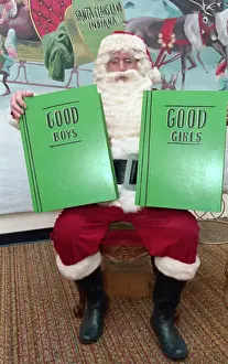 Man Dressed as Santa Claus Holding Books