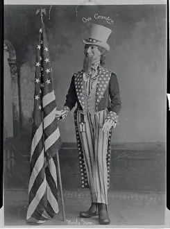 Man Dressed as Uncle Sam Grasping American Flag