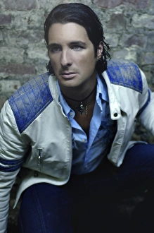 Leather Gallery: Man, early 30s, wearing a leather jacked in a basement, portrait