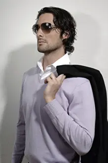 Man in his early thirties, wearing elegant clothes