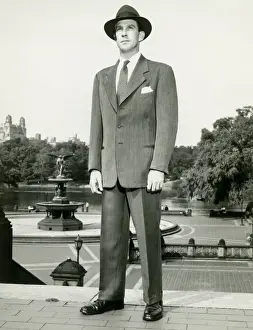 Business Man Prints: Man in fedora standing on top of steps in park