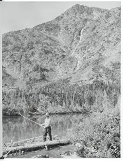 Man Fishing at a Lake