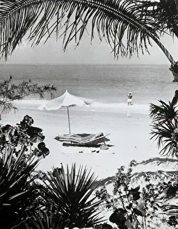 Sunbathing Prints: Man Fishing & Woman Sunbathing At Beach