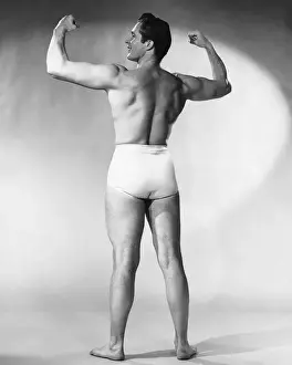 Legs Apart Prints: Man flexing muscles