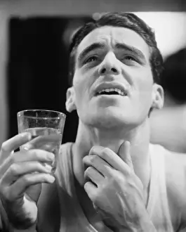 Open Mouth Prints: Man gargling, touching throat (B&W)