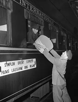 Express Prints: Man Handing Box to Porter on Train