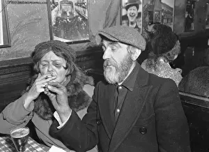 Man Helping Woman Light Cigarette