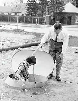 Garden City Prints: Man Helping Young Girl into Bomb Shelter