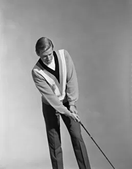 Images Dated 30th July 2011: Man holding golf club