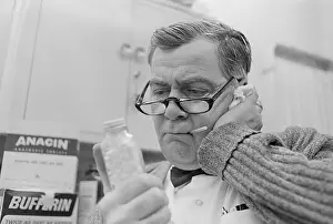 Thermometer Prints: Man Holding Pills While Taking His Temperature