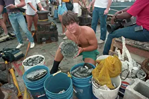 Key West Prints: Man Holding up Plate from Ship Wreck