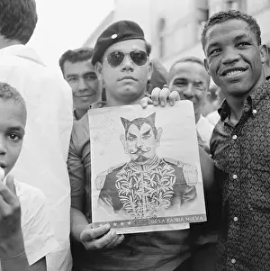 Man Holding Portrait of Trujillo