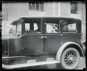 Man Holding Rifle in Police Car
