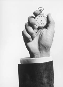Man holding stopwatch, close up of hand