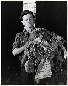 Overalls Prints: Man Holding Torn Fabric Scraps