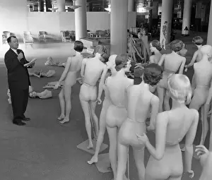 Man Inspecting Mannequins