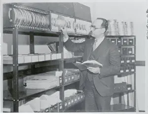 Quincy Prints: Man Inspecting Reels of Film