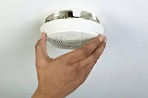 Images Dated 13th August 2009: Man installing smoke detector, close-up