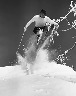 Man jumping through air on skis