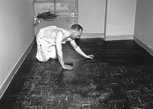 Bib Overalls Gallery: Man laying tiles on floor, (B&W)