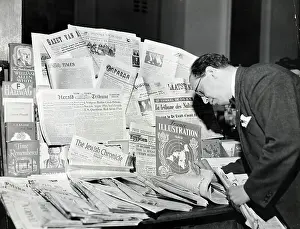 Global Prints: Man Leafs Through International News