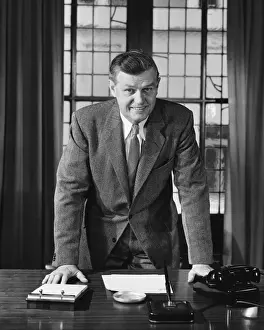 50 59 Years Prints: Man leaning on desk