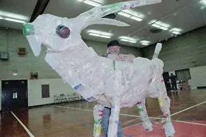 Recycling Prints: Man Leaning On Sculture; 10-Foot Goat
