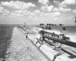 Trench Prints: Man Leaps Over Trench Before Pipe Put In