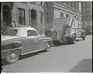 Man Loading Garbage Into Truck