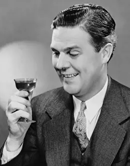 Man looking at drink