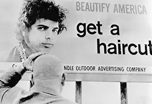 Man Looking at Large Sign