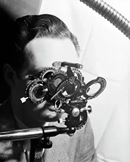 Optical Prints: Man Looking Into Phoropter