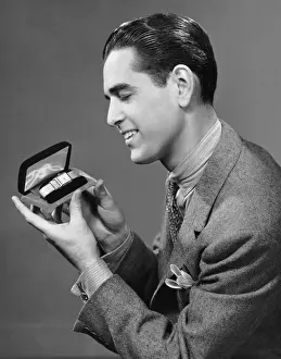 Man looking at watch in box
