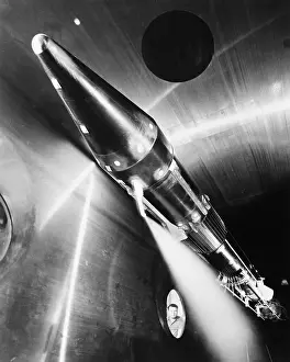 Hydrogen Prints: Man Looks Through Window at Rocket in Room