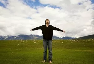 Cloudy Sky Collection: Man with open arms, Jasper, Canada
