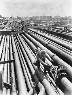 Man Opening Oil Pipeline Valve