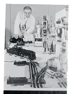 Man Operating a Toy Train